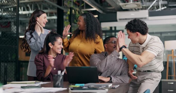 Excited, team and celebration at laptop in office for viral campaign, ROAS target and brand deal. Tech, happy people and applause with high five at marketing agency for pitch win, ad growth or goals