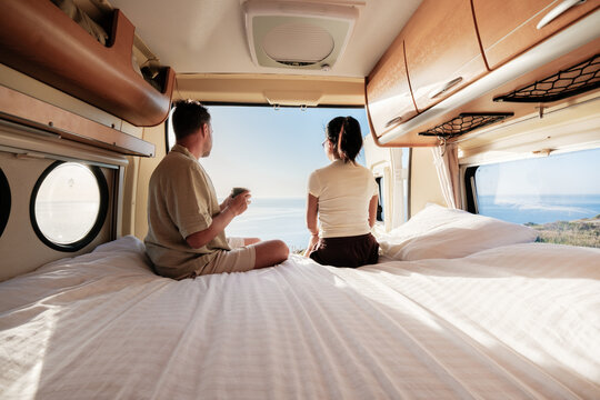 Couple enjoying a serene morning view in a van overlooking Chalkidiki's stunning coastline