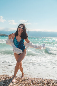 Woman in blue swimsuit by Adriatic sea