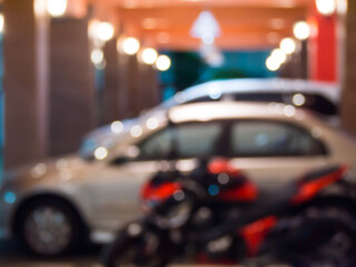 Abstact burred car in hotel parking at night background.