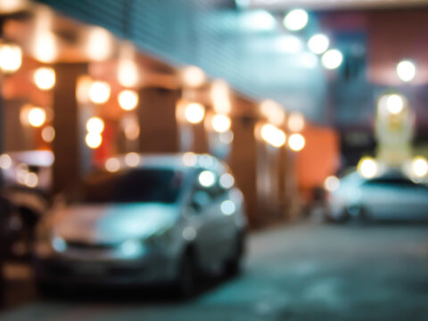 Abstract burred car in hotel parking at night background.