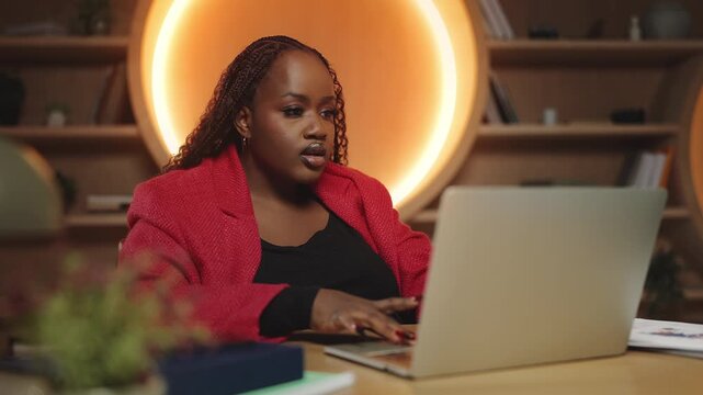 African American businesswoman celebrating a good news email in office, success
