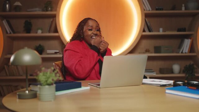 Black woman reading a good news email and screaming yes, business grant winner