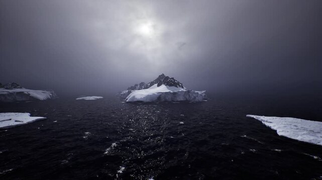 Small research vessel approaching iceberg, crepuscular light casting long reflections, mountain peak shrouded in mist, instruments and survey intent implied,