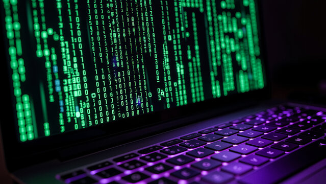 Laptop screen displaying green digital code