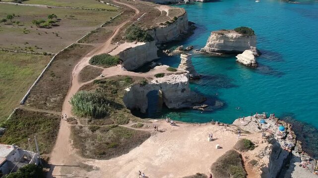 Italy, Puglia, Top Down Aerial of Torre Sant'Andrea Rock Formations and Crystal Clear Sea, Ocean, Beach