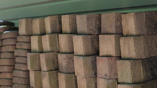 A stack of bricks used for a retaining wall, panning left.