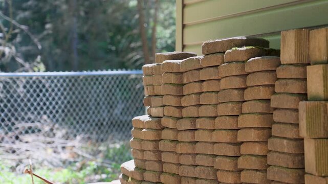 Paver bricks stacked in the shade on a hit summer day.