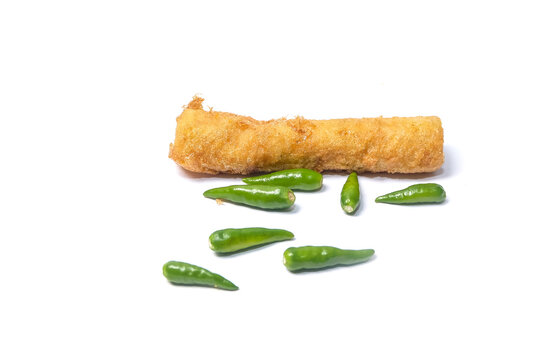 A golden fried spring roll resting on a white background,