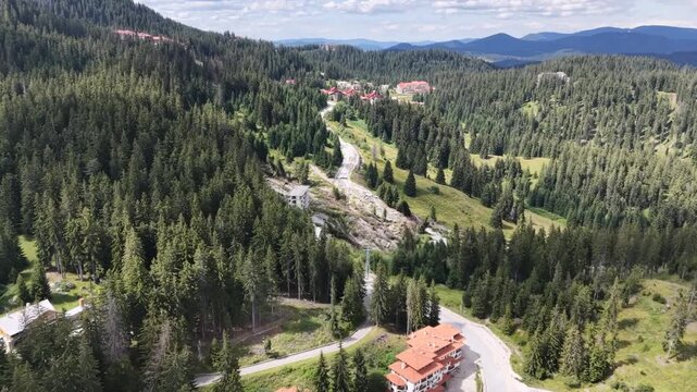 Aerial view of mountain landslide disaster near road and resort in Pamporovo