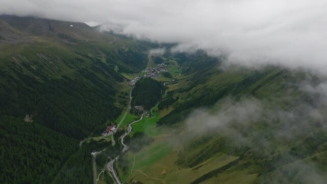 Drone aerial footage of Timmelsjoch pass in the Tyrol Alps on the Austria Italy border with majestic cloud covered mountains stunning natural landscapes and unforgettable European travel destination