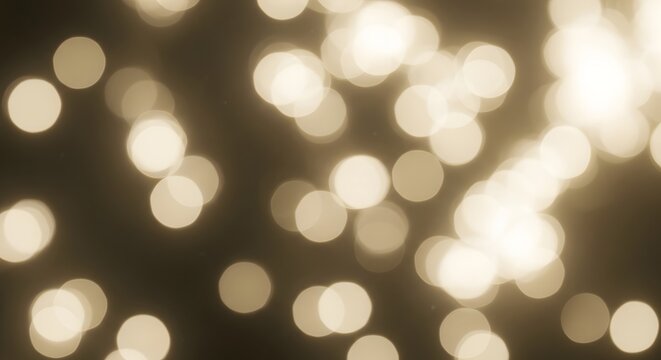 Abstract golden bokeh lights background on dark surface.