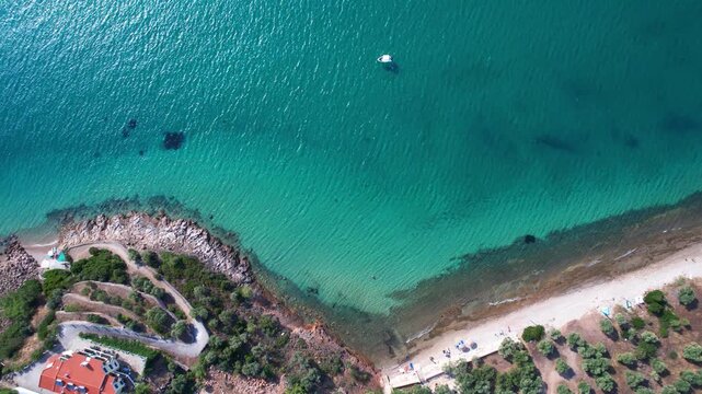 Aerial drone view of a powerful speed boat gliding across crystal-clear turquoise water, creating a striking white wake. Perfect representation of luxury travel, freedom, summer adventure.