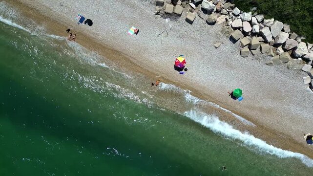 Panoramic aerial of a tranquil beach near a fishing hut 4k drone