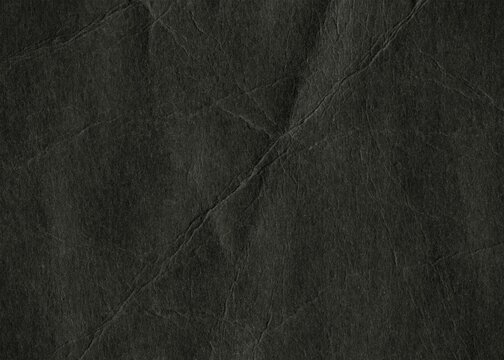 Crumpled black thick paper background. Wrinkled paper frame canvas for design. Black drawing board material.