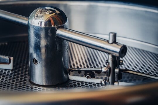Close up of a stainless steel agitator inside a coffee roasting drum during roasting process.
