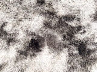 Detailed texture background of soft grey and white natural animal fur or synthetic faux fur pelt, ideal for fashion, interior design, and winter themes. © elsa 