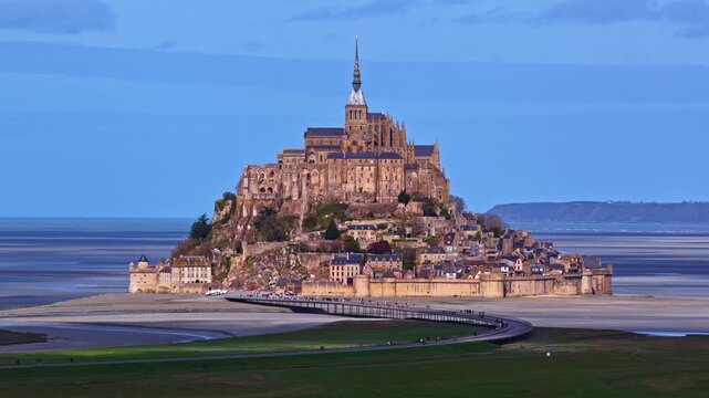 Aerial view of the historic Mont Saint-Michel abbey and village situated on a tidal island surrounded by vast sand flats in France.
