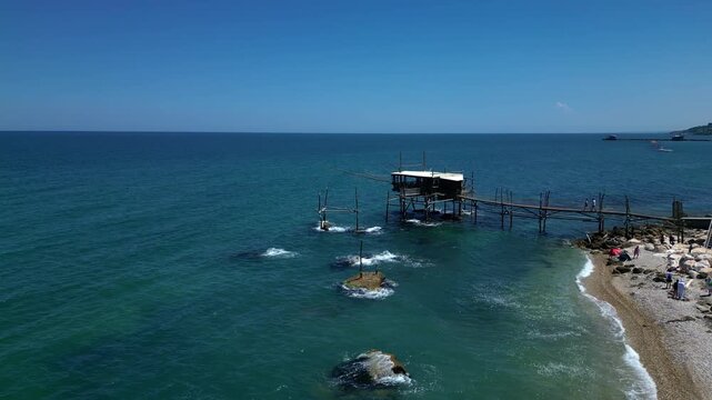 Wide aerial of a fishing hut over the open sea 4k drone