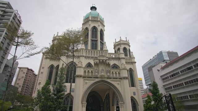 Historic Saint Joseph Church in Singapore with elegant Catholic architecture surrounded by downtown skyscrapers creating a unique cityscape and tourism landmark in Asia