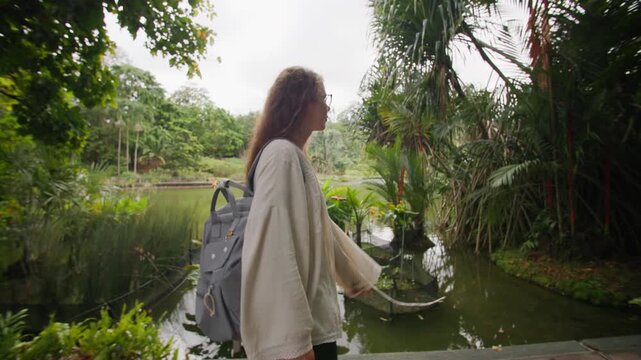 Traveler discovering lush tropical plants in Singapore Botanic Gardens with beautiful natural landscapes and peaceful urban scenery in Asia