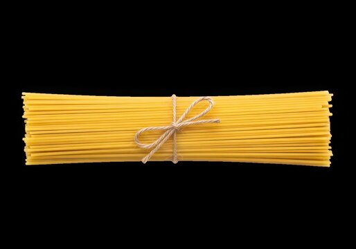 Golden spaghetti with broken fork on black background isolated on white background