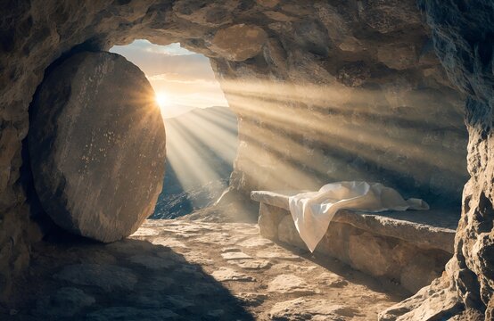 Bright morning sunlight rays shining into empty stone tomb cave with folded linen clothes on slab for traditional christian happy easter resurrection holiday religious celebration background.