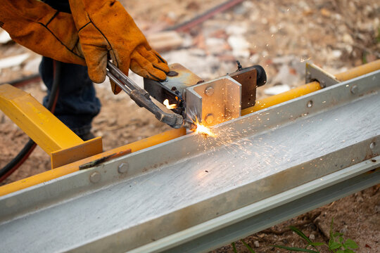 Skilled worker precisely cutting metal beam with torch demonstrating craftsmanship
