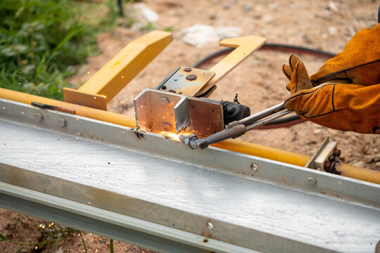 Metal structure clamped in vise during assembly process at workshop