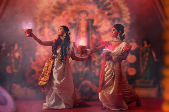 Bengali women performing dhunuchi dance on the occasion of Durga Puja