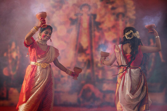 Bengali women performing dhunuchi dance on the occasion of Durga Puja