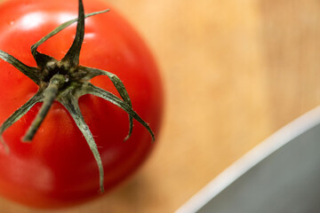 Fototapeta na wymiar Fresh tomato on wooden surface.