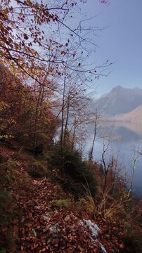 Panning shot of famous Lake K&ouml;nigssee with ship and mountains in Nationalpark Berchtesgaden in autumn, Bavaria, Germany 