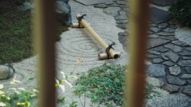 Japanese zen rock garden with raked sand and bamboo