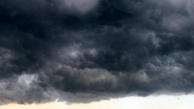 Dramatic dark storm clouds rolling across sky before heavy rain