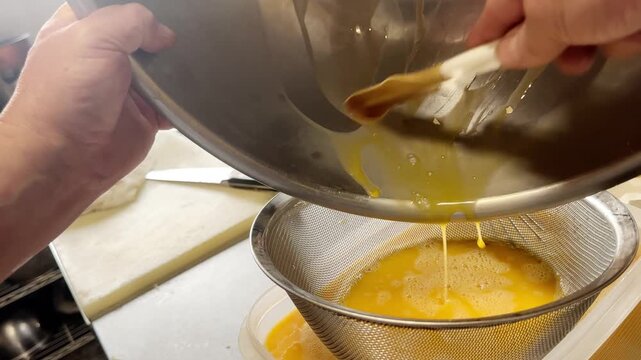 Straining Beaten Eggs Through a Fine Sieve for Japanese Dashimaki Omelette, Japan