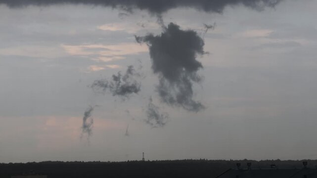 Low dark storm cloud fragment hanging over horizon before rain