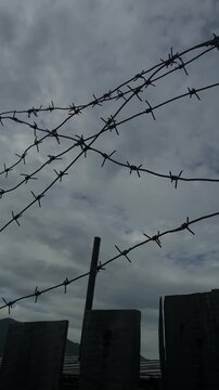 Low angle vertical shot of barbed wire fence at a former gulag camp in Ust-Nera Russia