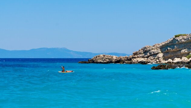 Kokkari, Greece - July 26, 2026: View of the sea and rocky coastline from Paralia Kokkari beach on Samos Island, Greece, showing clear blue Aegean water, and coastal rocks