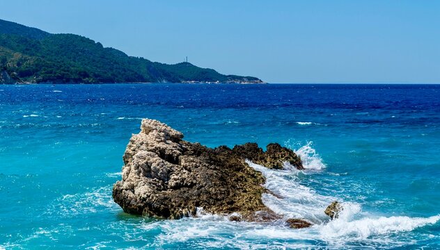 Kokkari, Greece - July 26, 2026: View of the sea and rocky coastline from Paralia Kokkari beach on Samos Island, Greece, showing clear blue Aegean water, and coastal rocks