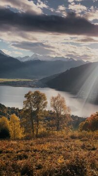 Panning shot of Zell am See fall mountain scenery with lake and Kitzsteinhorn glacier at sunset, Salzburg Land, Austria	