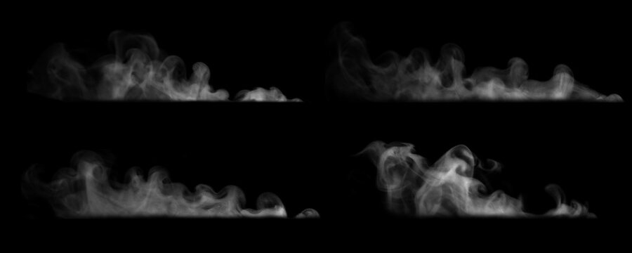 Set of white steam, vapor, or smoke swirls isolated on a black background. Concept of hot food vapor, cooking steam, coffee aroma, atmospheric effects, and thermal mist texture element.