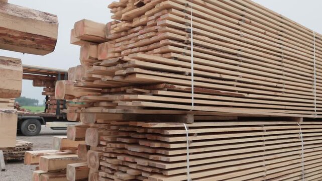 Close-up of bundled rough-sawn wooden boards and beams stacked for drying, storage, or construction at an outdoor timber yard