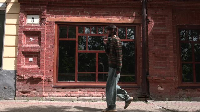 man walking past urban street scene with brick building and windows, neutral side view, everyday life, red brown commercial natural light clean background copy space editorial educational.