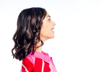 Young woman smiling in profile wearing pink striped top against white background, studio portrait with confident, cheerful expression and copy space © deagreez