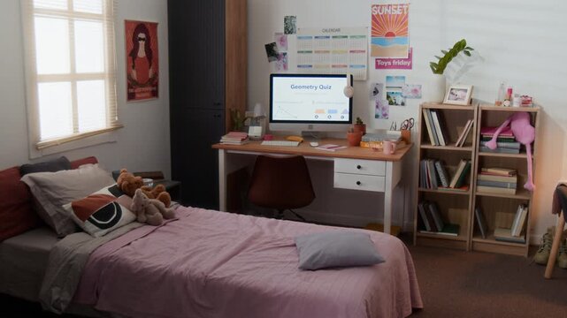 Computer monitor displaying geometry quiz sitting on desk in empty teenager bedroom, camera zooming in. Footage is ideal for online education and e-learning marketing campaigns