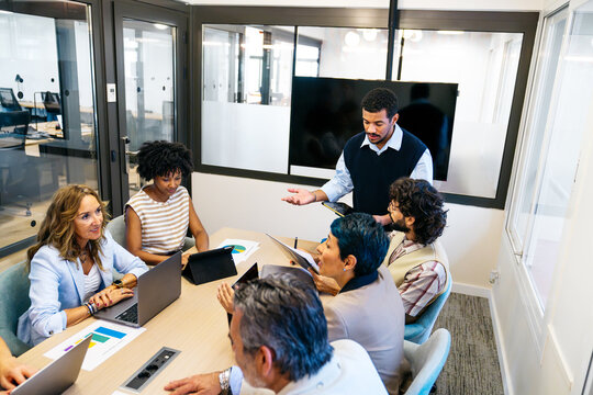 Professionals working together, discussing ideas and planning projects in a modern cooperative office environment