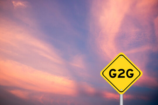 Yellow transportation sign with word G2G (abbreviation of Government to government) on violet color sky background