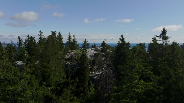 Aerial view of dense coniferous forest and rocky outcrops in Koli National Park in Koli, Pohjois-Karjala, Finland.