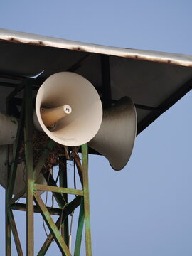 Mosque Loudspeaker Mounted on Tower Against Blue Sky